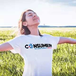 A woman in a Consumer Air t-shirt enjoys the fresh outdoor air of spring.
